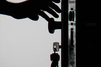 Silhouette Photo of Person Holding Door Knob